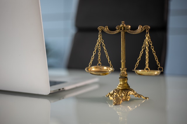 photo of a scales of justice on a desk