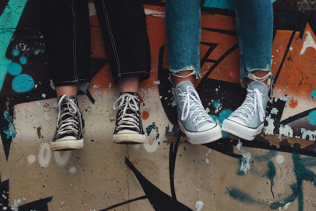 photo of two teenagers feet in shoes