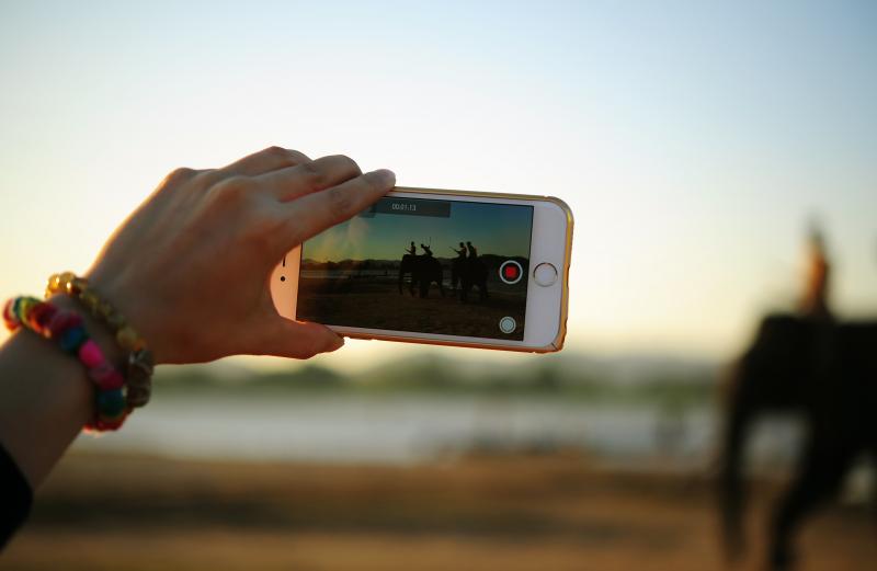young person filming on a mobile phone