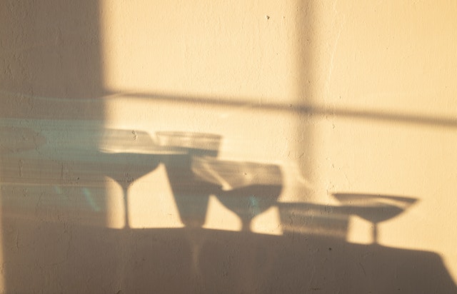 shadows of wine and alcohol glasses on the wall