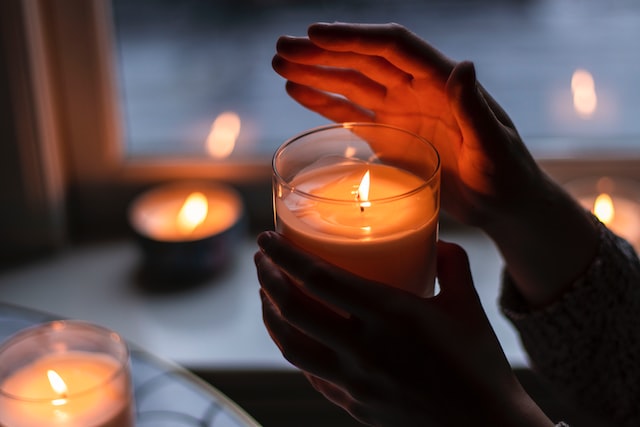 person holding a candle at night