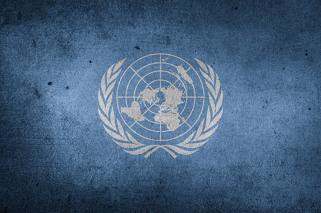 photo of the United Nations logo on dark blue background