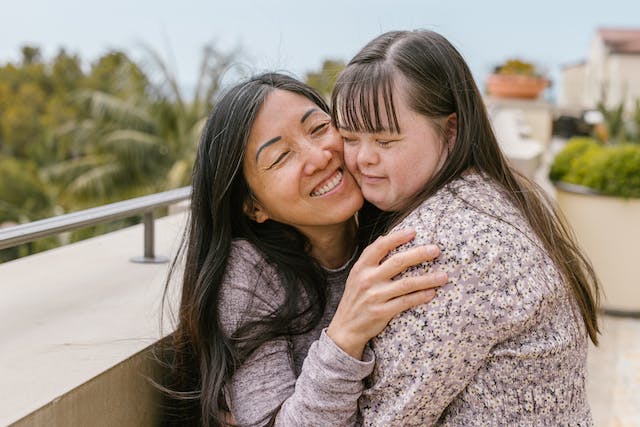 photo of a mother hugging daughter who has a disability